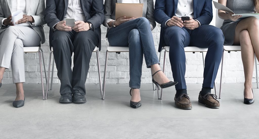 Men and Women in Business Attire Waiting to Be Interviewed